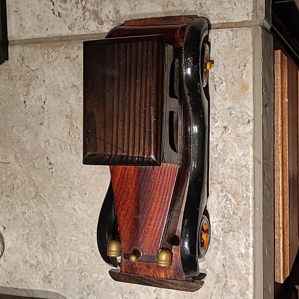 A handmade car made out of wood mostly as I can tell painted nicely this